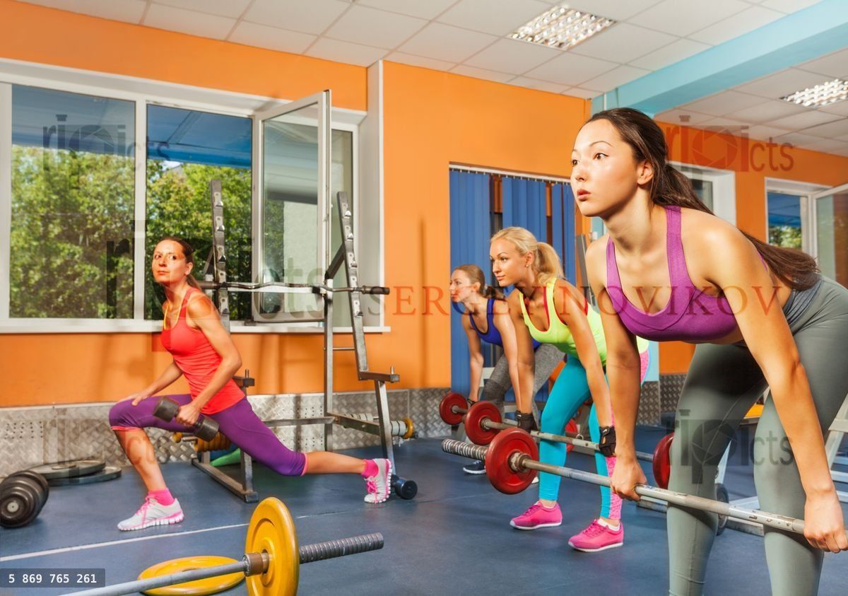 Group weight lifting class in fitness club