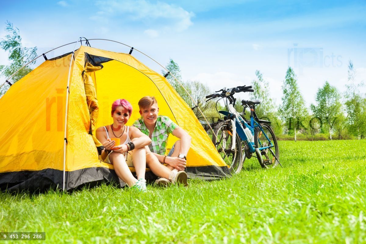 Yong couple with bikes in a tent