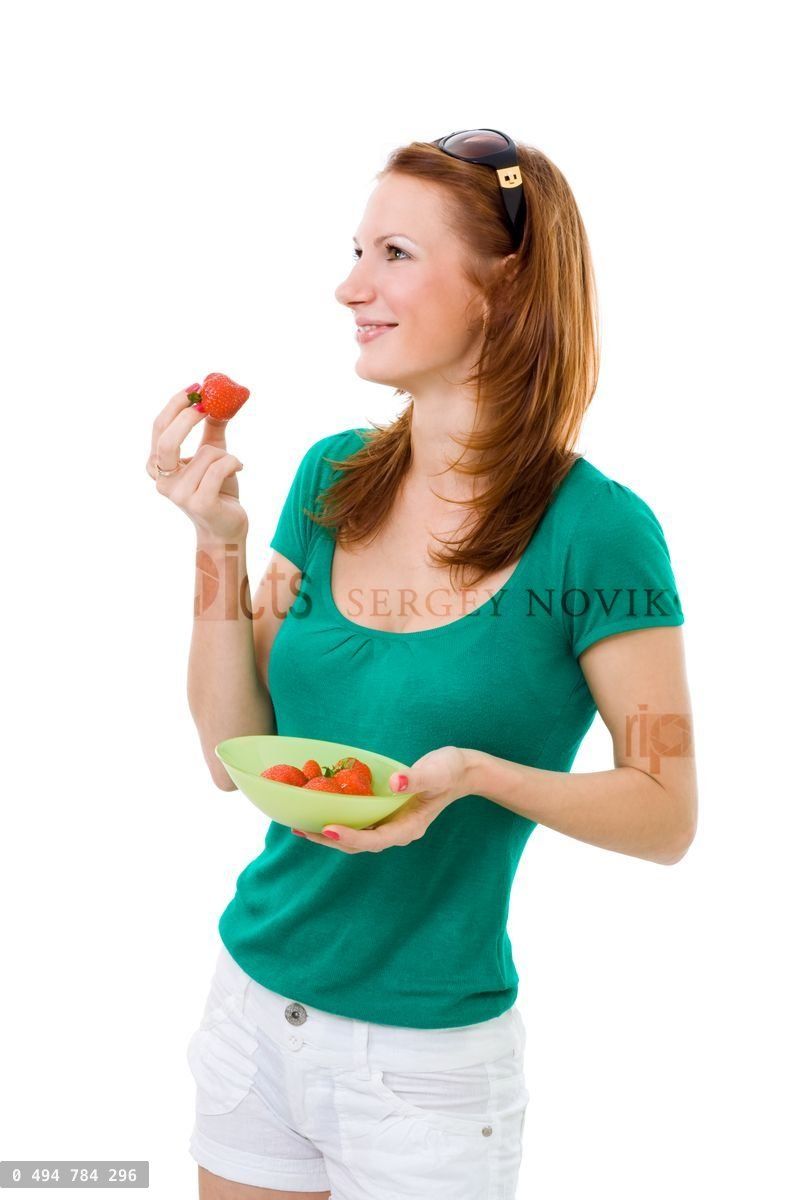 Woman eating strawberry