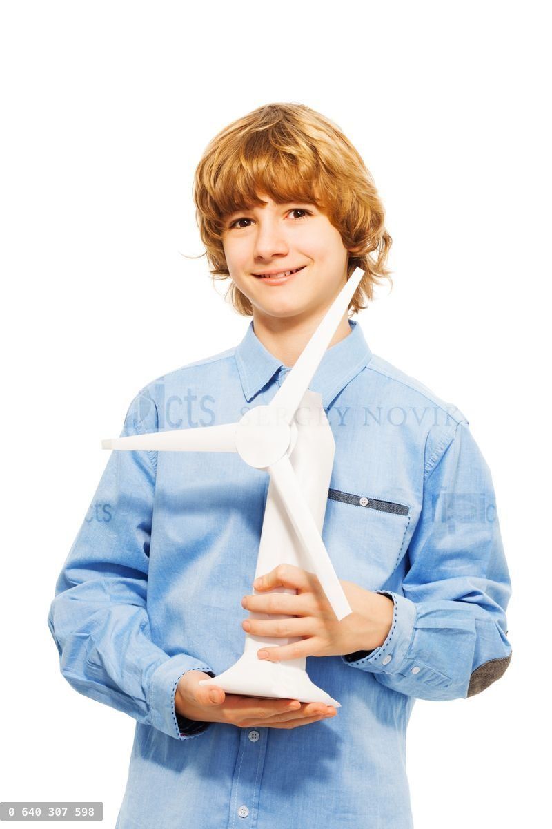 Young boy holding model of wind generator turbine