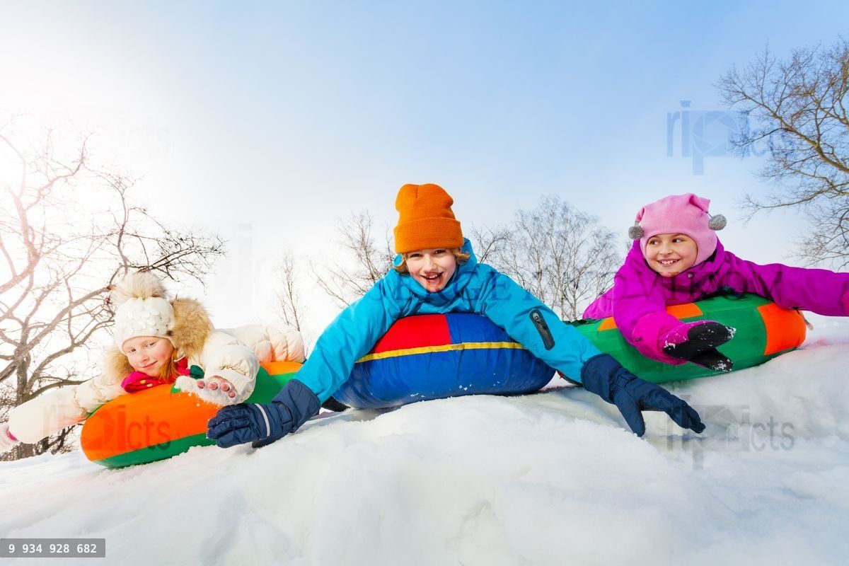 Group of children sliding on the colorful tubes