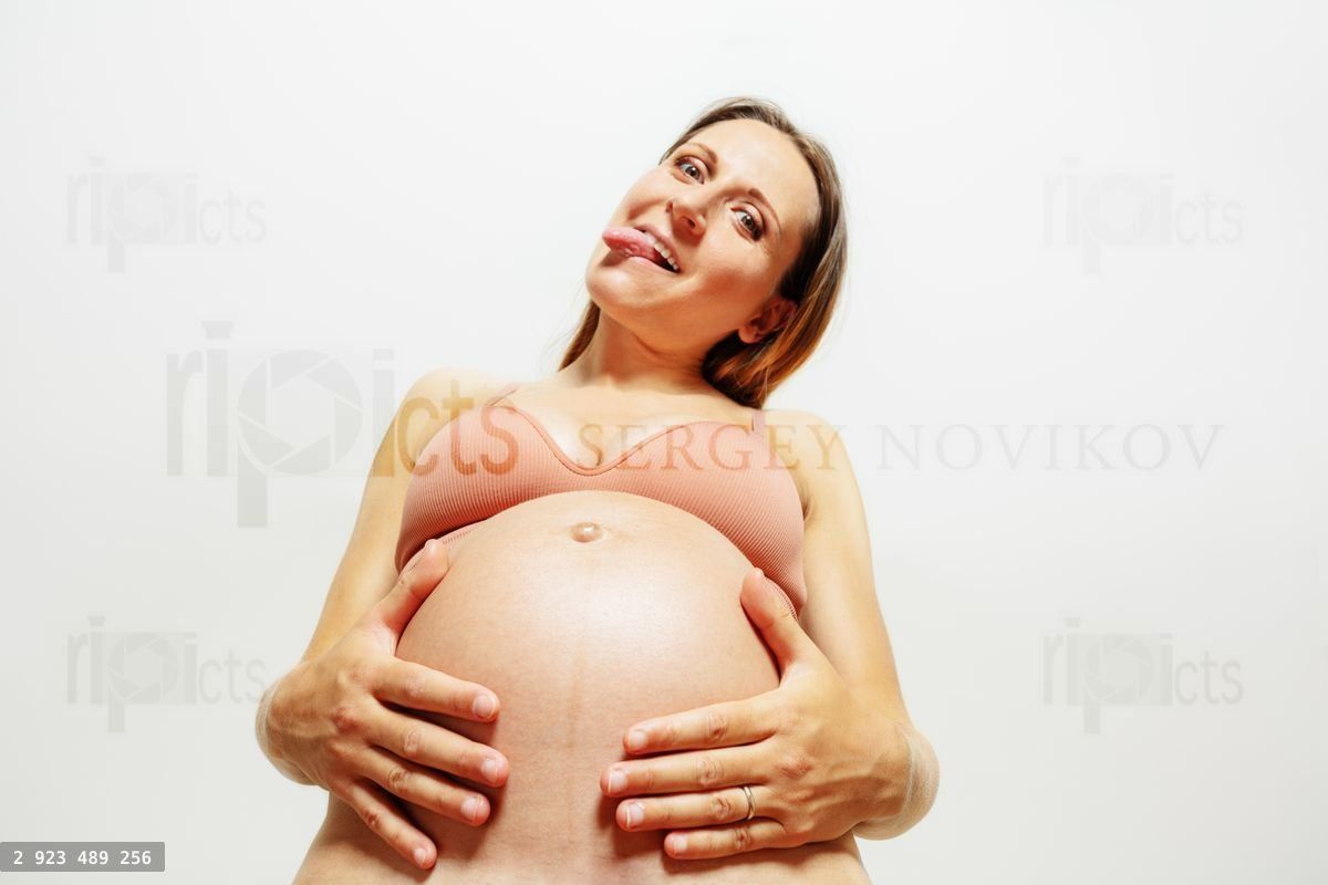 Funny pregnant woman stick out tongue look down