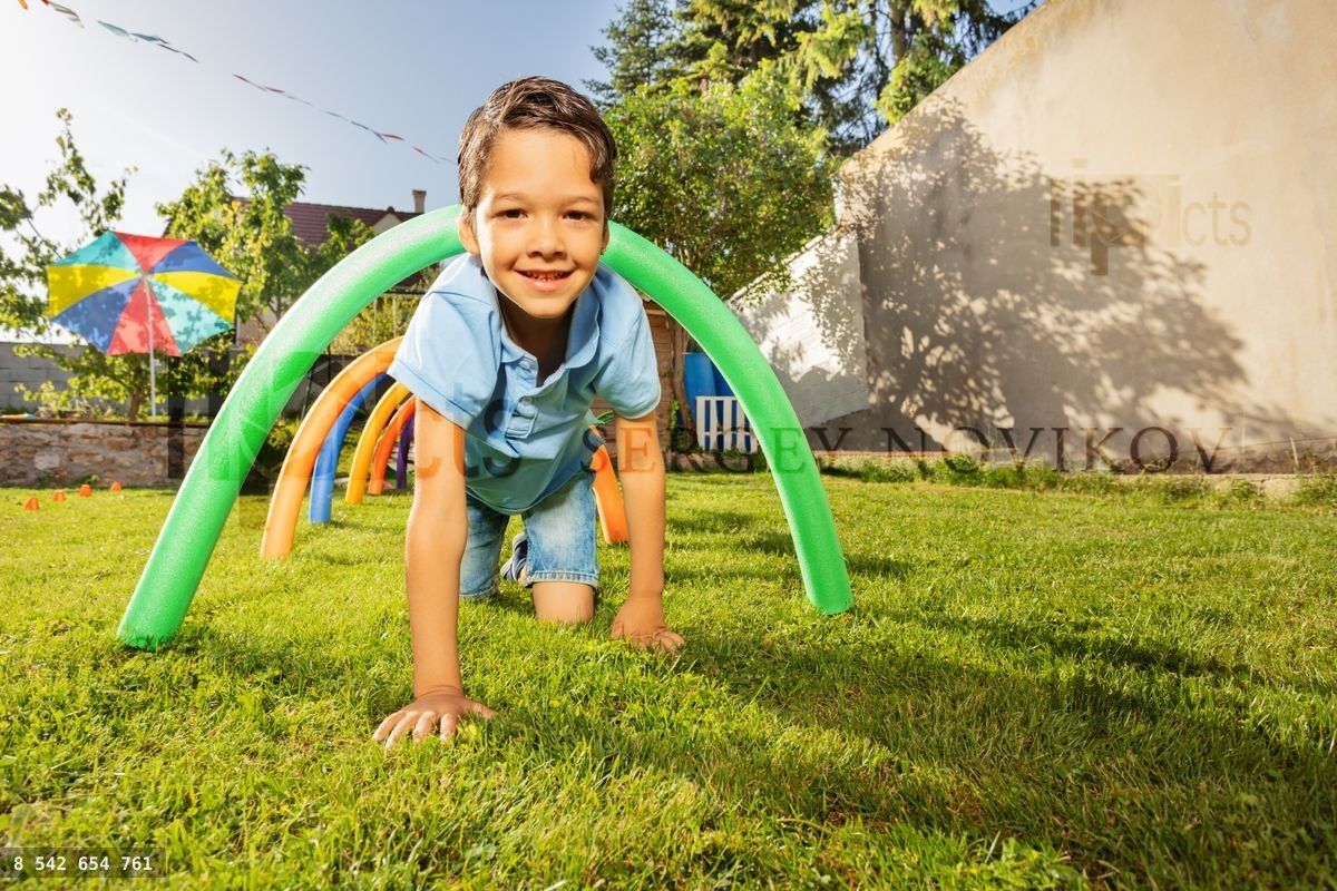 Happy boy crawl under barrier in competitive game