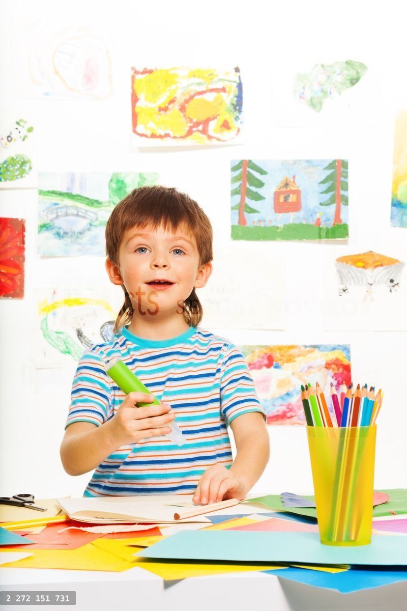 Boy with glue stick and pencils