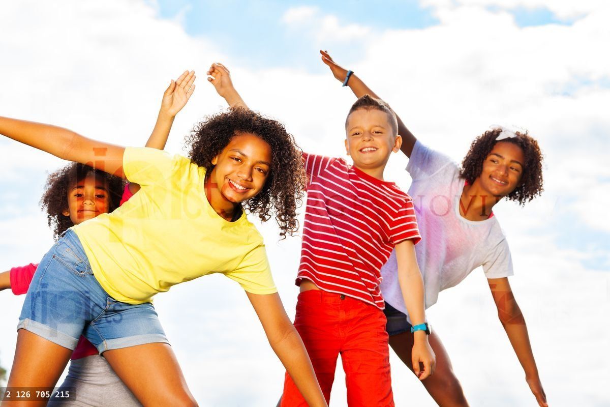 Group of kids smile bending, leaning together
