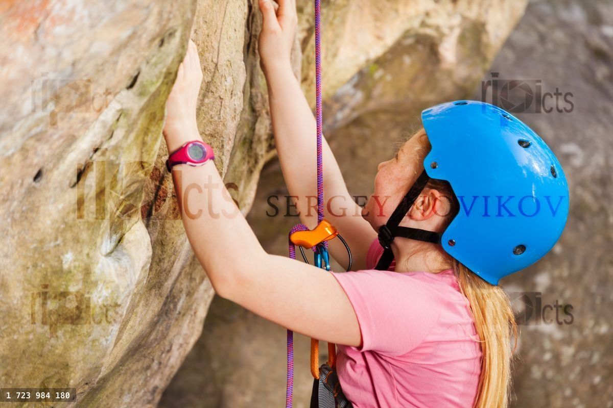 Young rock climber training in the mountains
