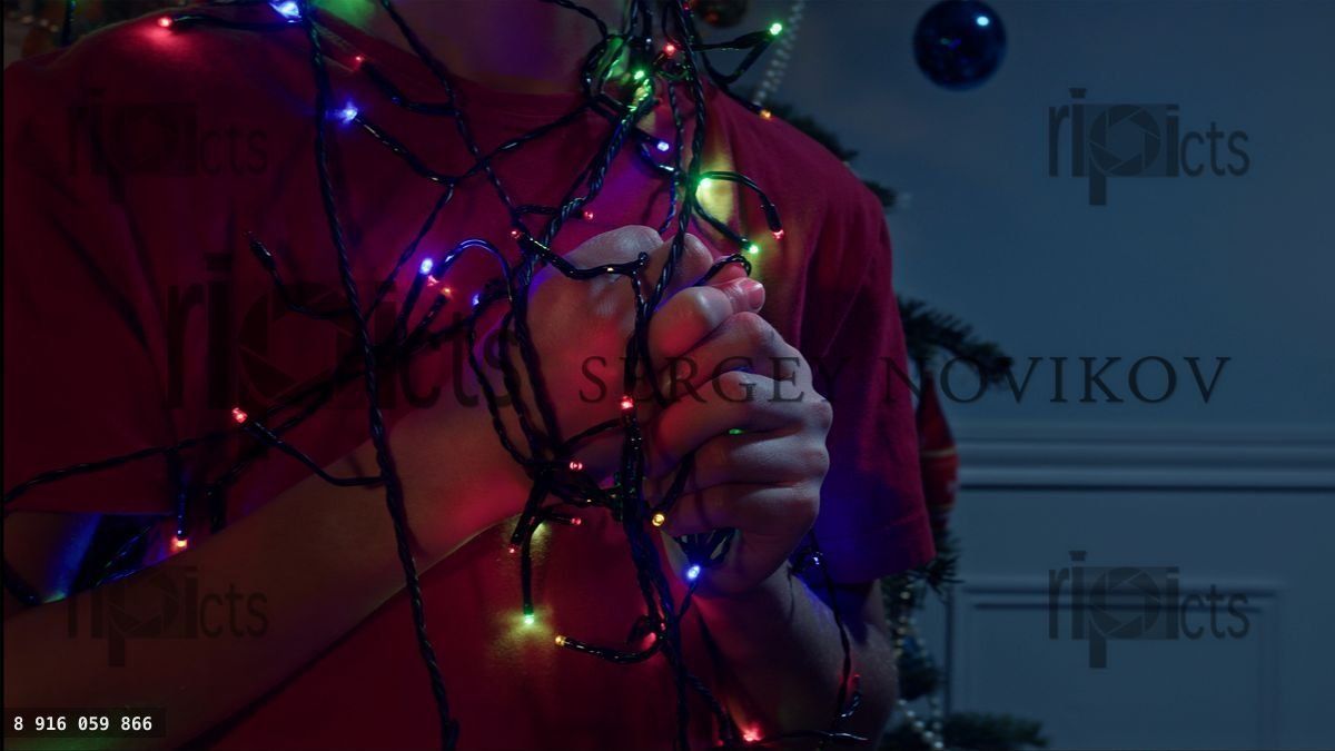 Hands of the boy with illumination garland lights