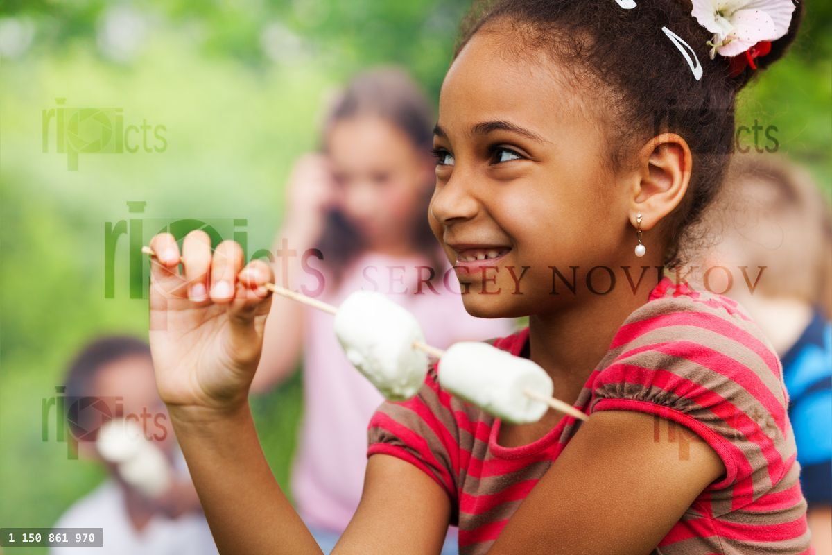 Portrait of African girl and marshmallow stick