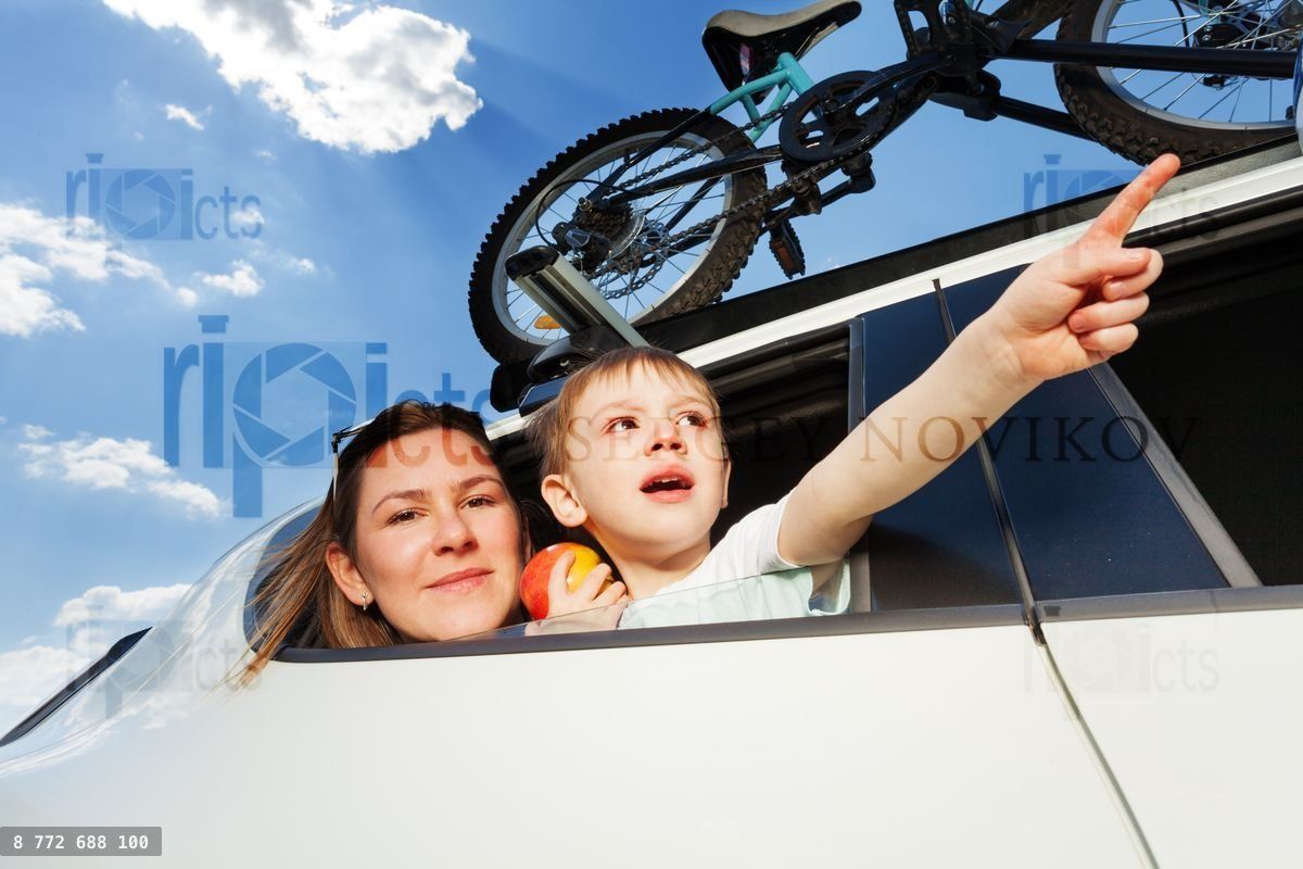 Young mother and her kid travelling by car