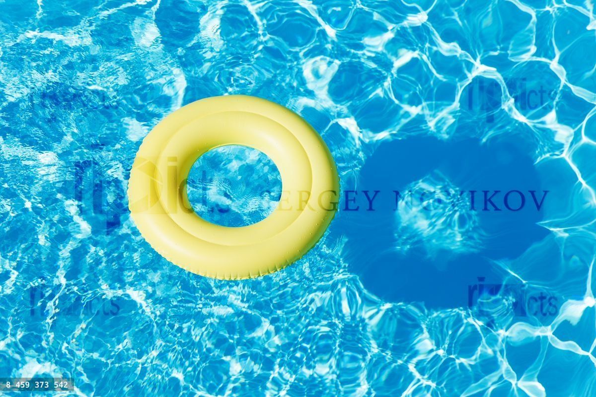 Yellow rubber ring floating on the water surface