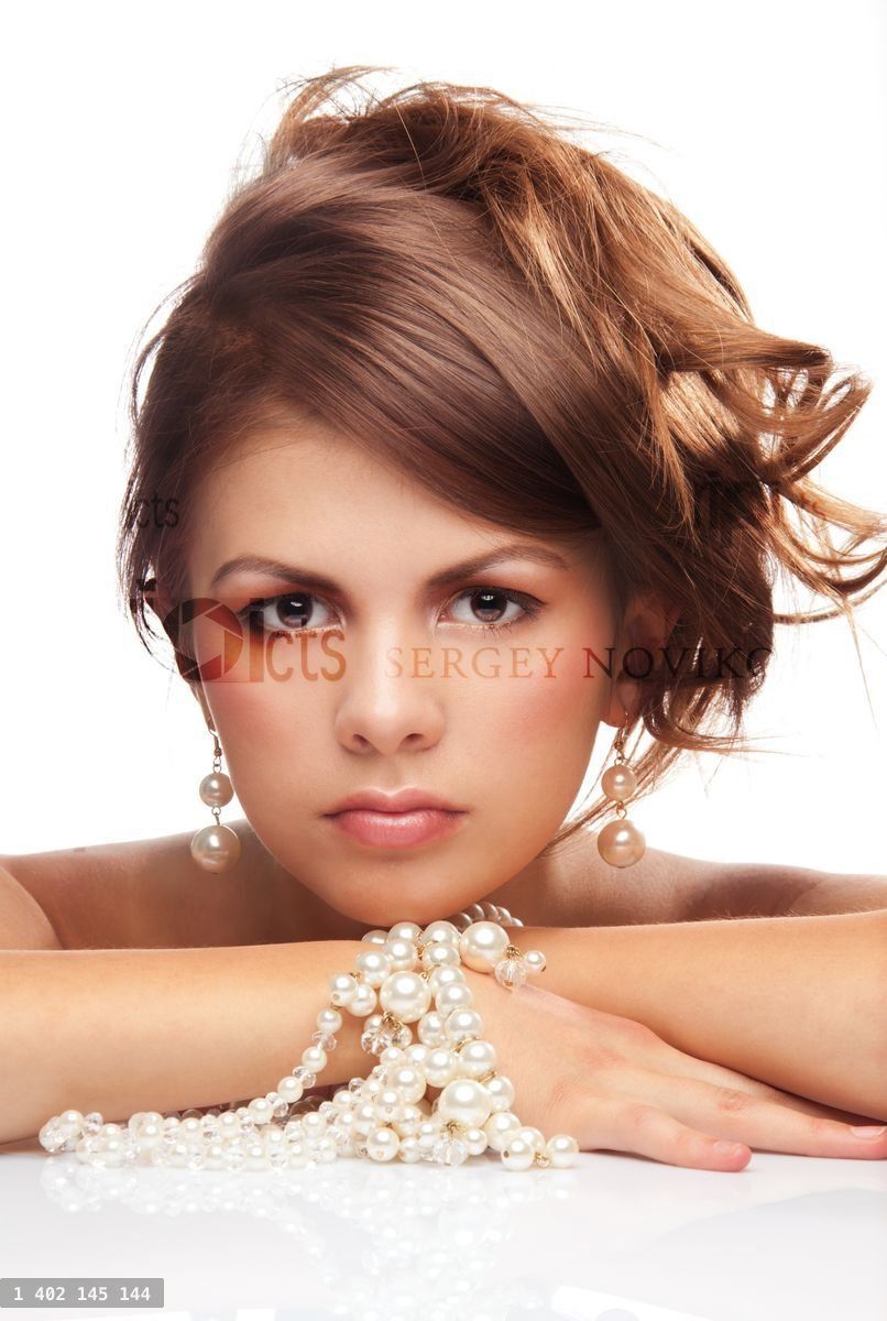 Woman with pearls necklace laying on her hands