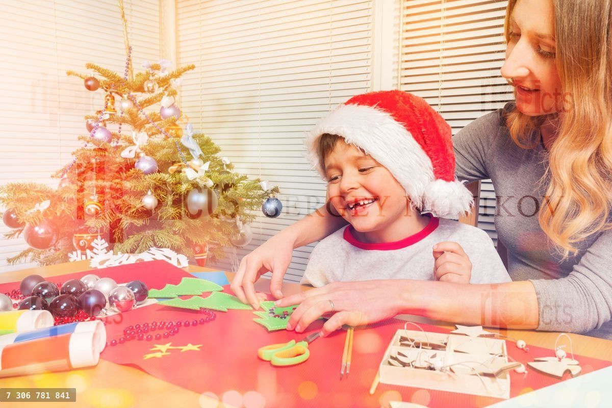 Young mom making Christmas ornaments with her son
