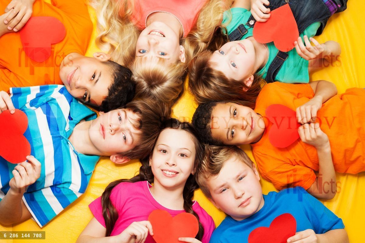 Boys and girls in circle with hearts