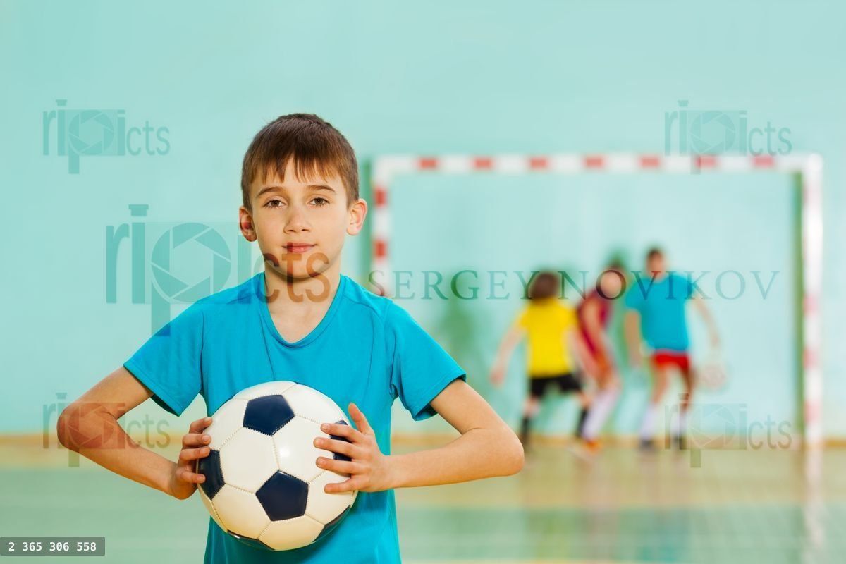 Young football player ready to throw soccer ball