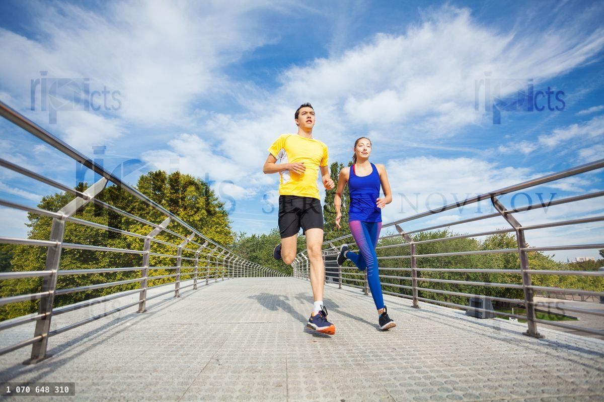 Young fitness couple running outdoors