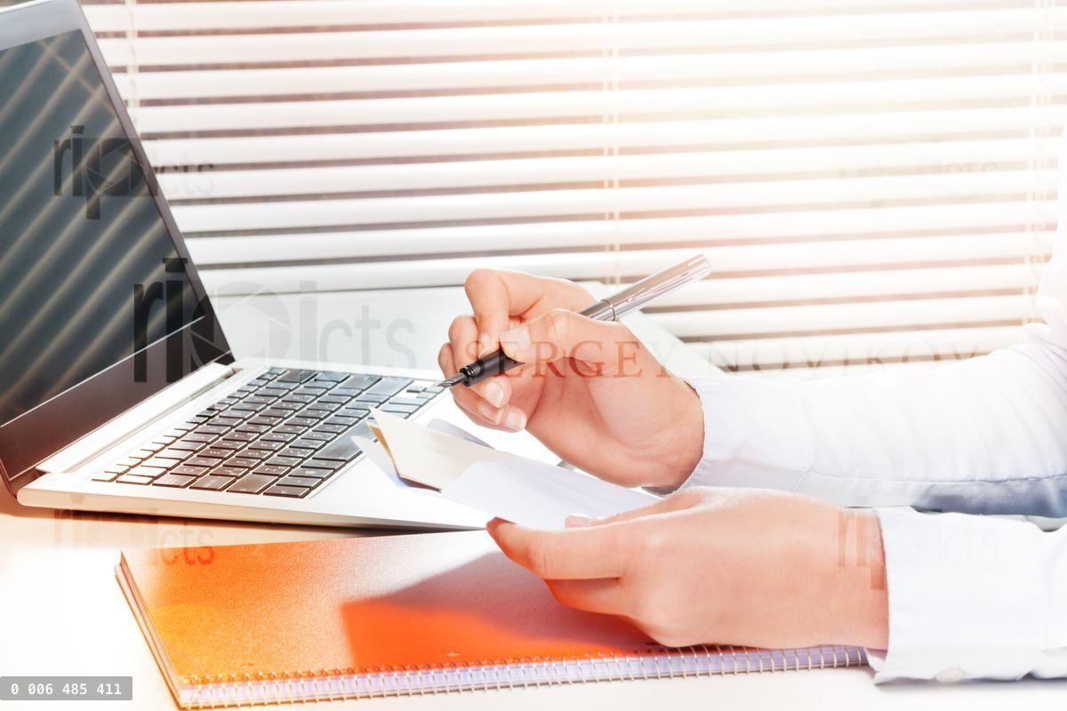 Woman working with papers and making notes