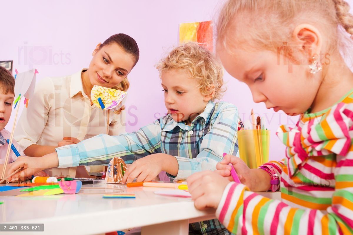 Teacher and little children crafting in class