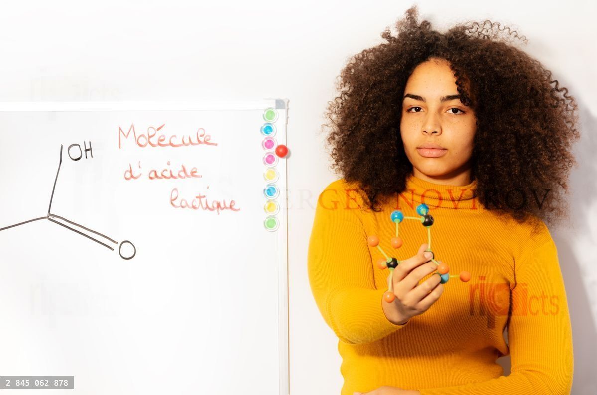 young woman in chemistry class show acid molecule