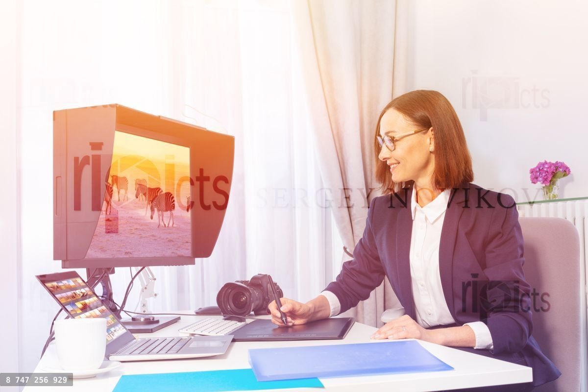Woman using digital drawing monitor in the office