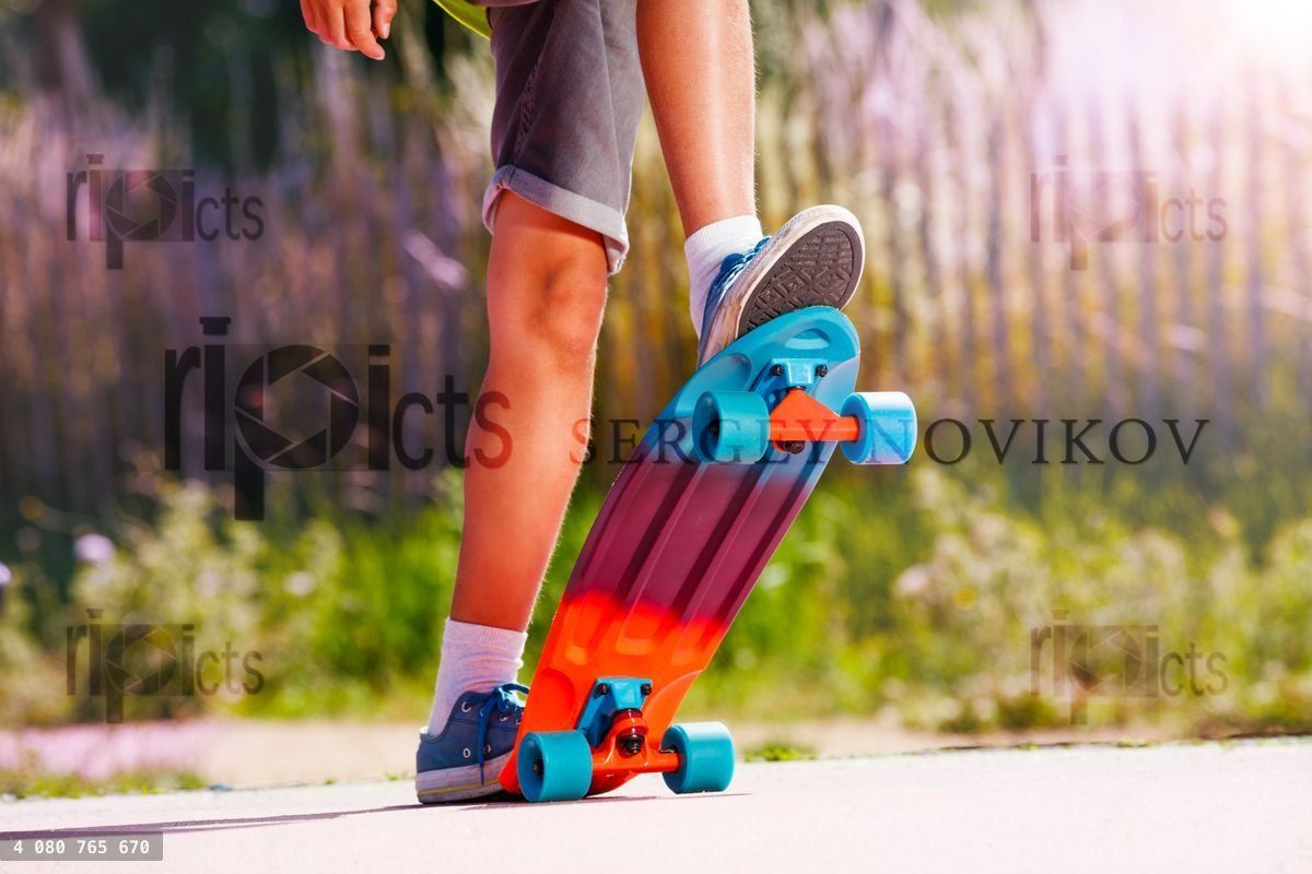 Close up of a skater boy stand on skateboard at skating park
