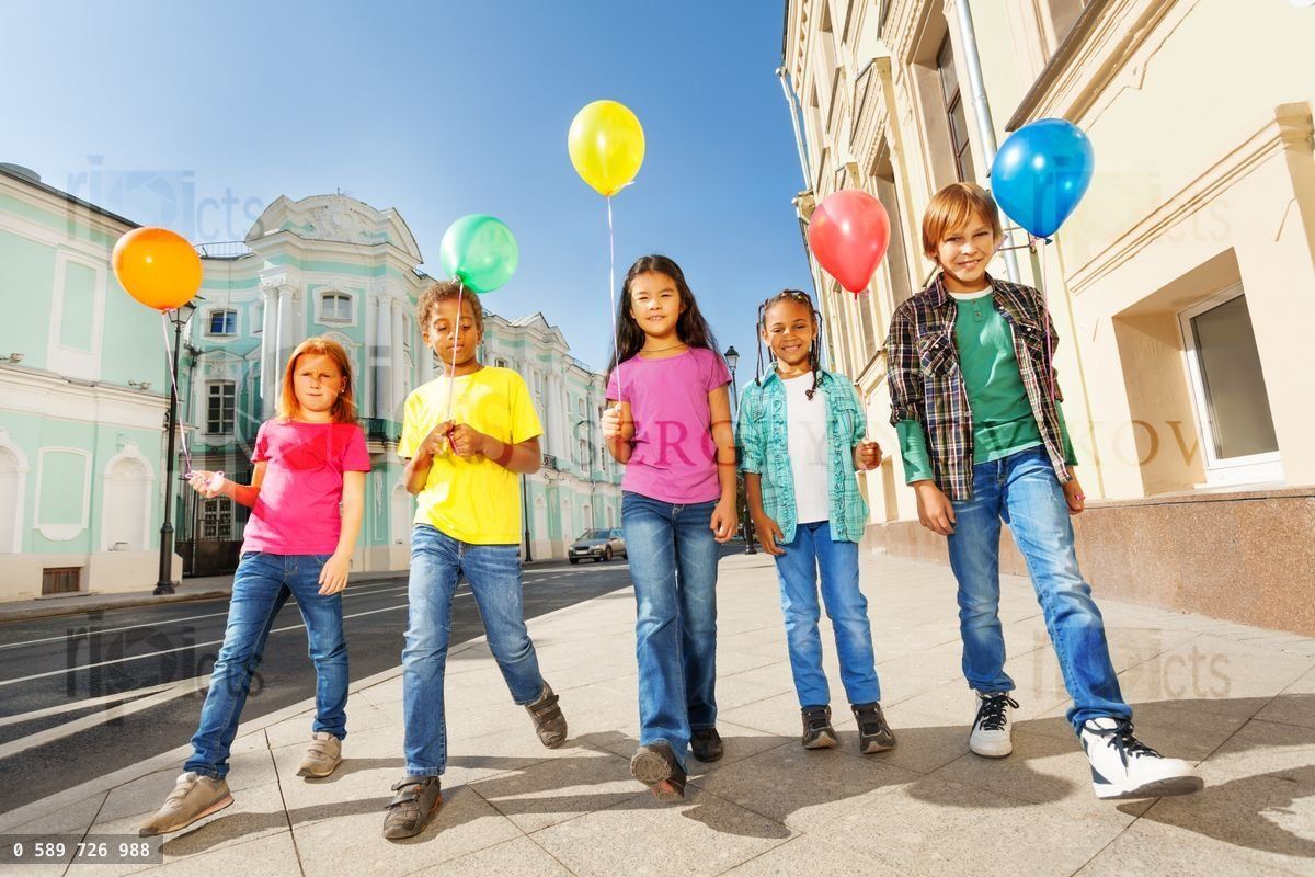 Walking children diversity with colorful balloons