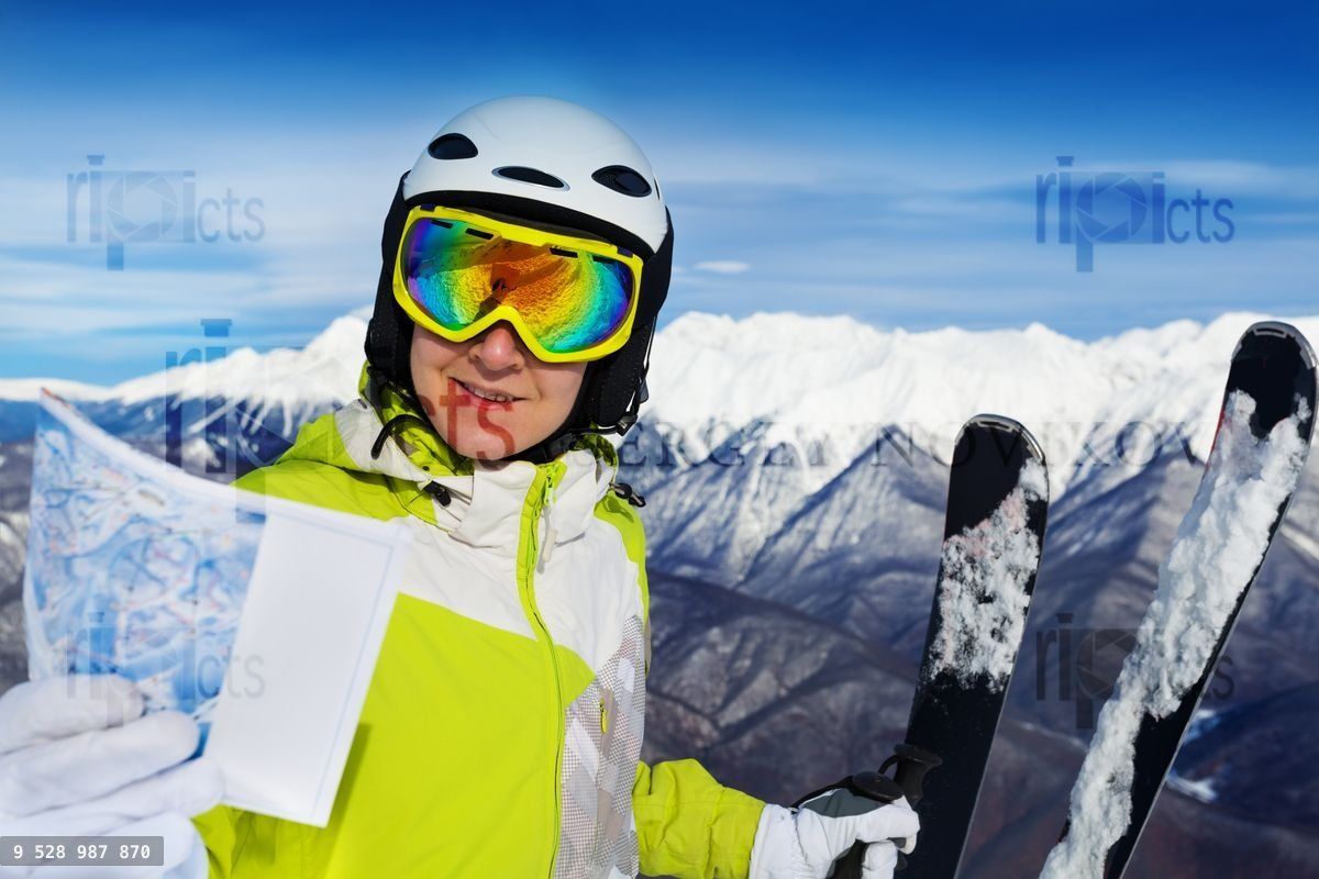 Woman with ski track map on the mountain