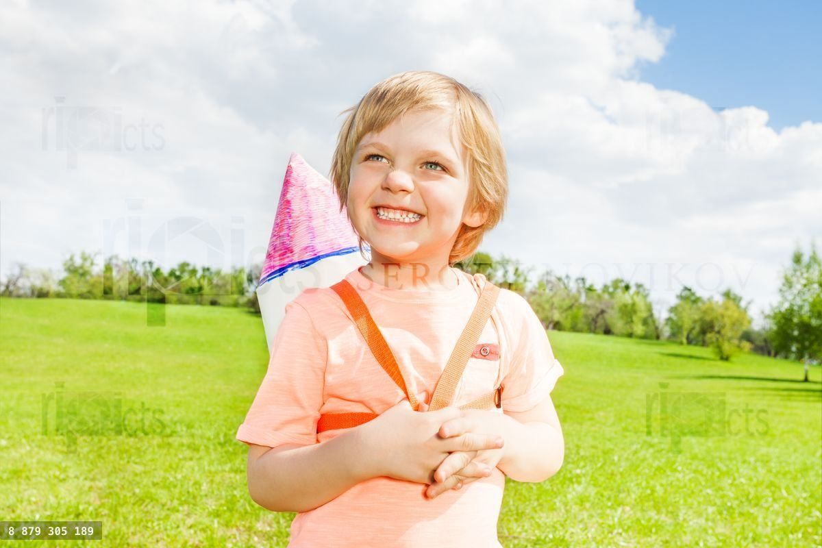 Close up of smiling boy with carton rocket toy