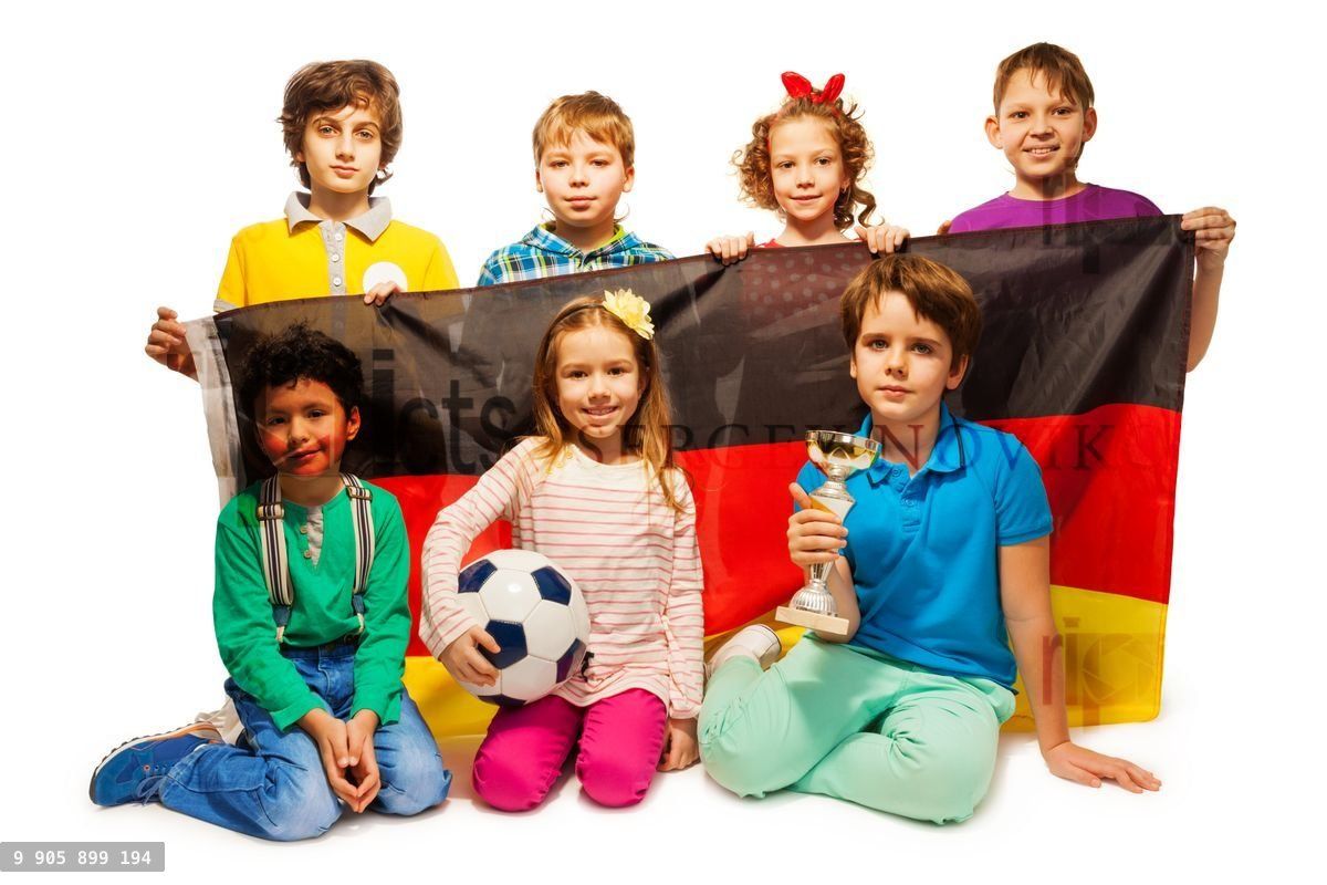 Young German football players with a cup and ball