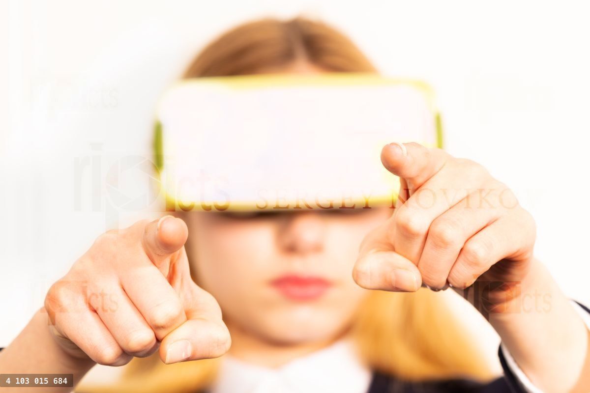 Woman in VR headset control game with fingers