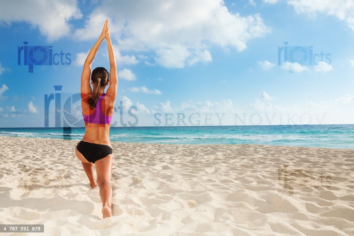 Yoga exercises on the beach