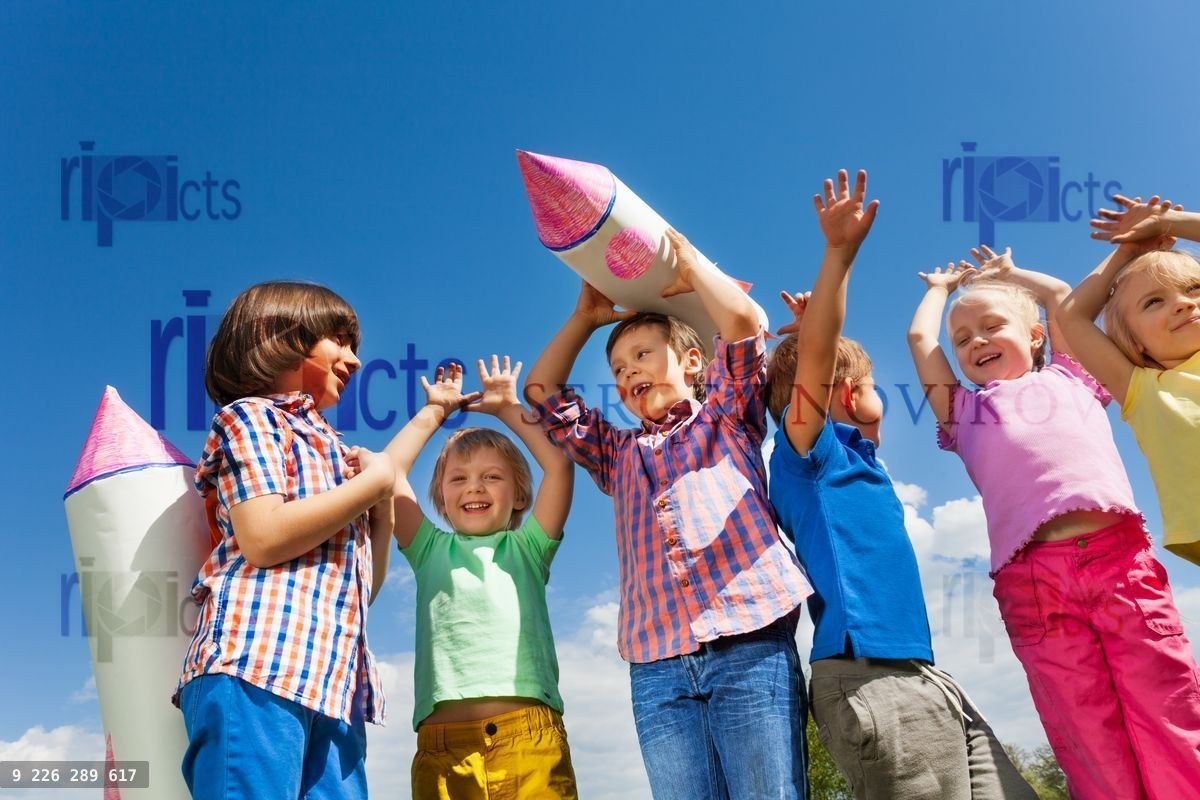 Close up of children stand with paper rocket toy