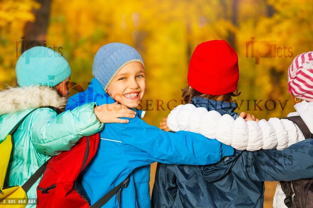 Back view of happy children with rucksacks