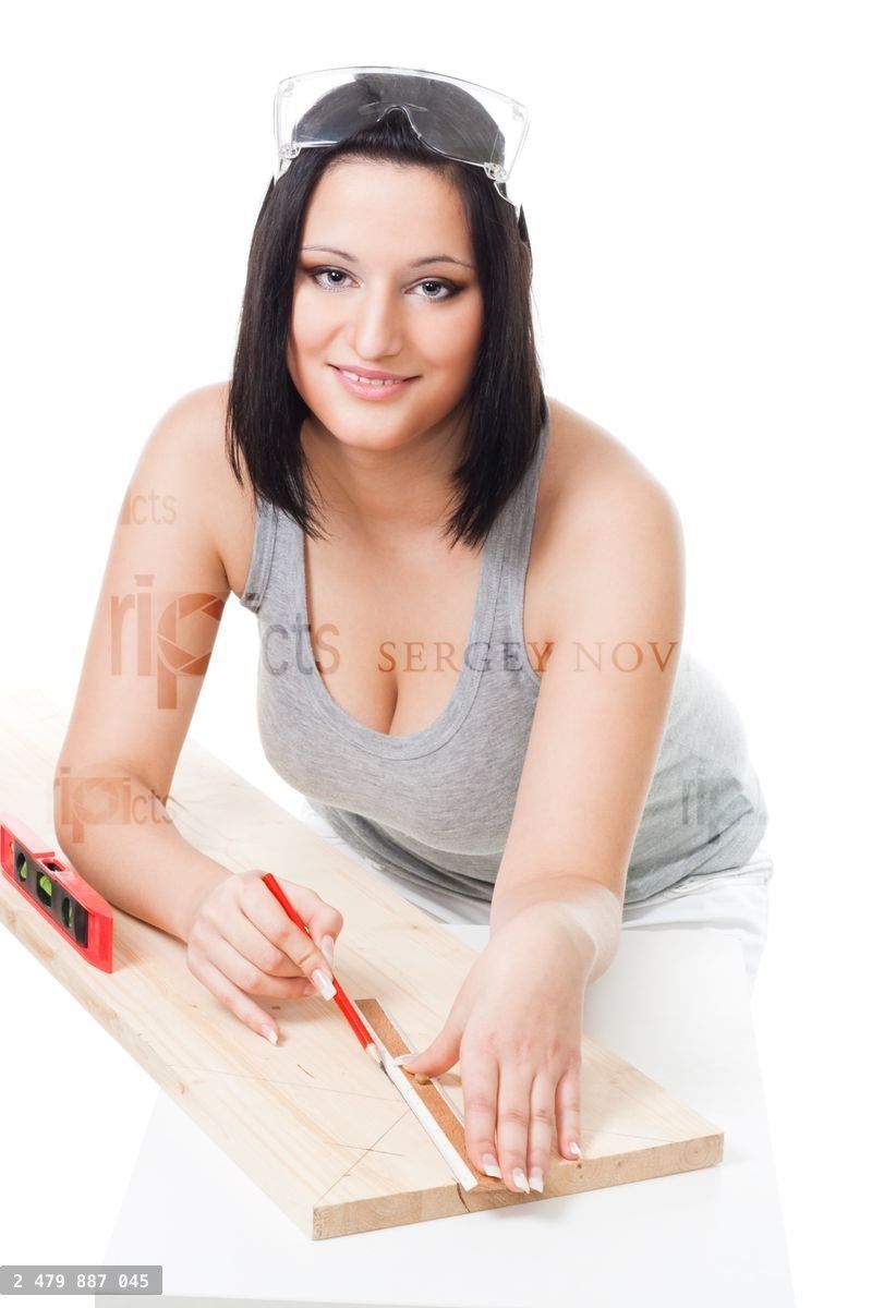 Woman measuring wood plank