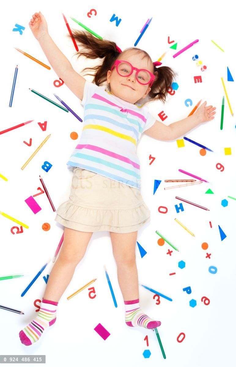 Funny girl laying among school office supplies