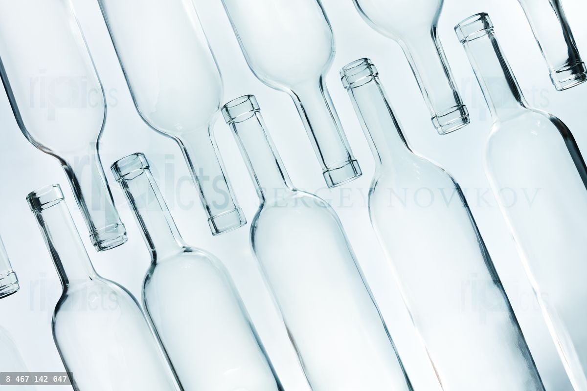 Crystal glass empty bottles laying in two lines