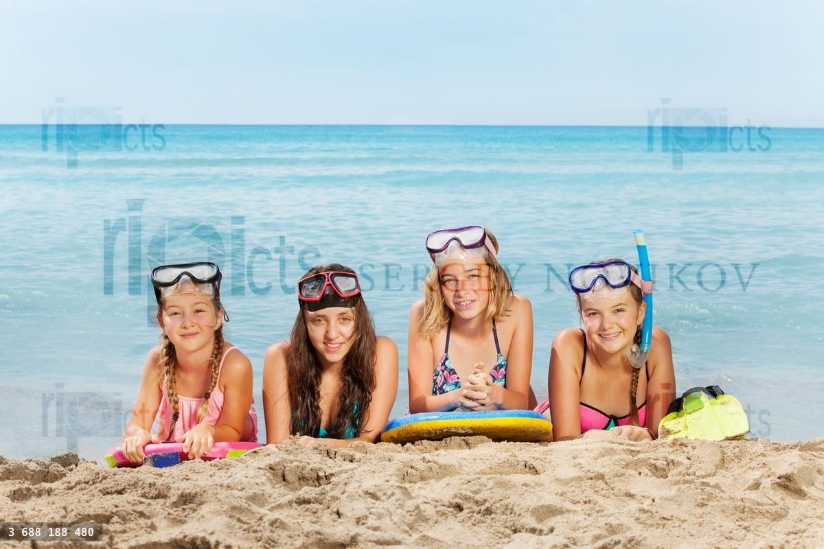 Four happy girls on summer sea vacation