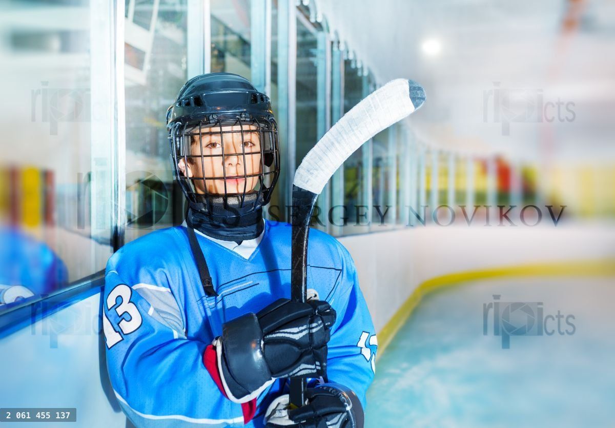 Young hockey player in protective equipment
