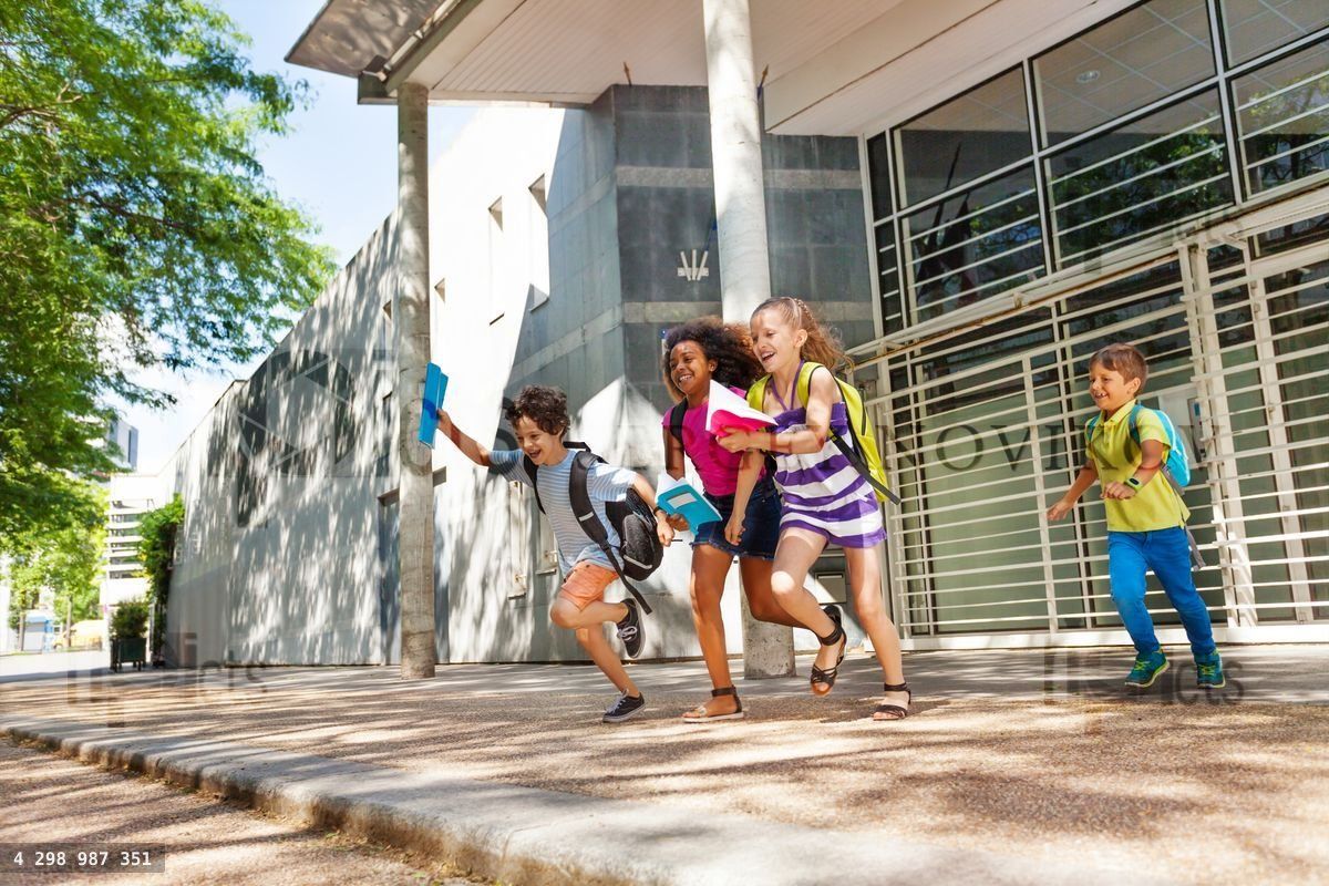 Group of kids run from the school