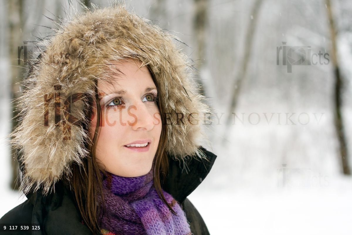 Woman in forest with fur hood