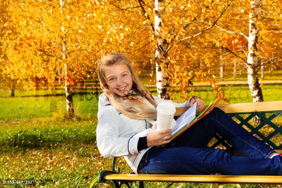 Happy blond girl with coffee and textbooks