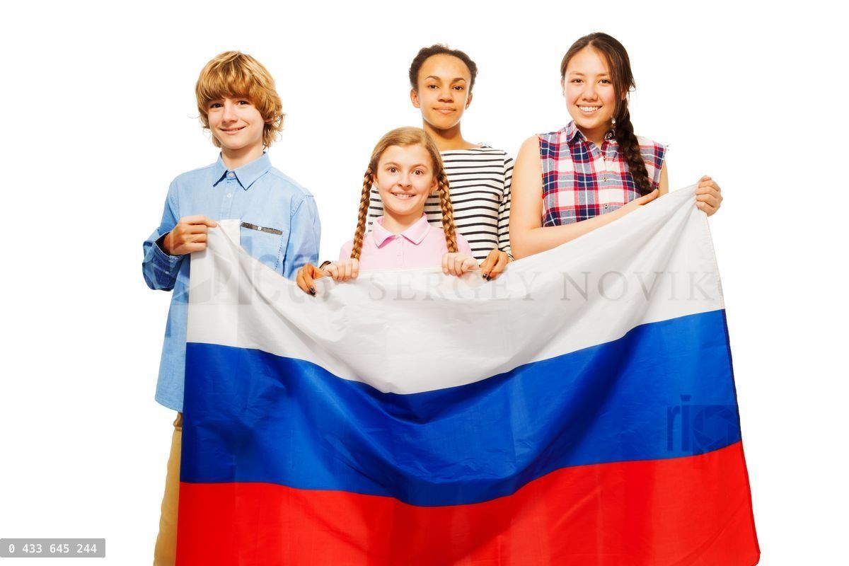 Four teenage kids with flag of Russian Federation