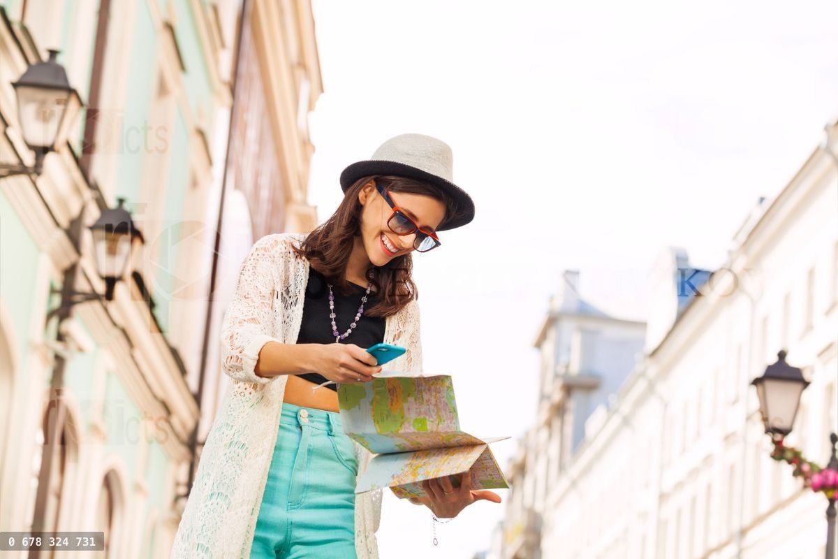 Gros plan d'une fille avec un téléphone mobile et une carte de ville