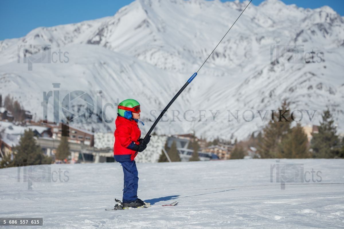 Young skier rids the slopes with vibrant gear and stunning views