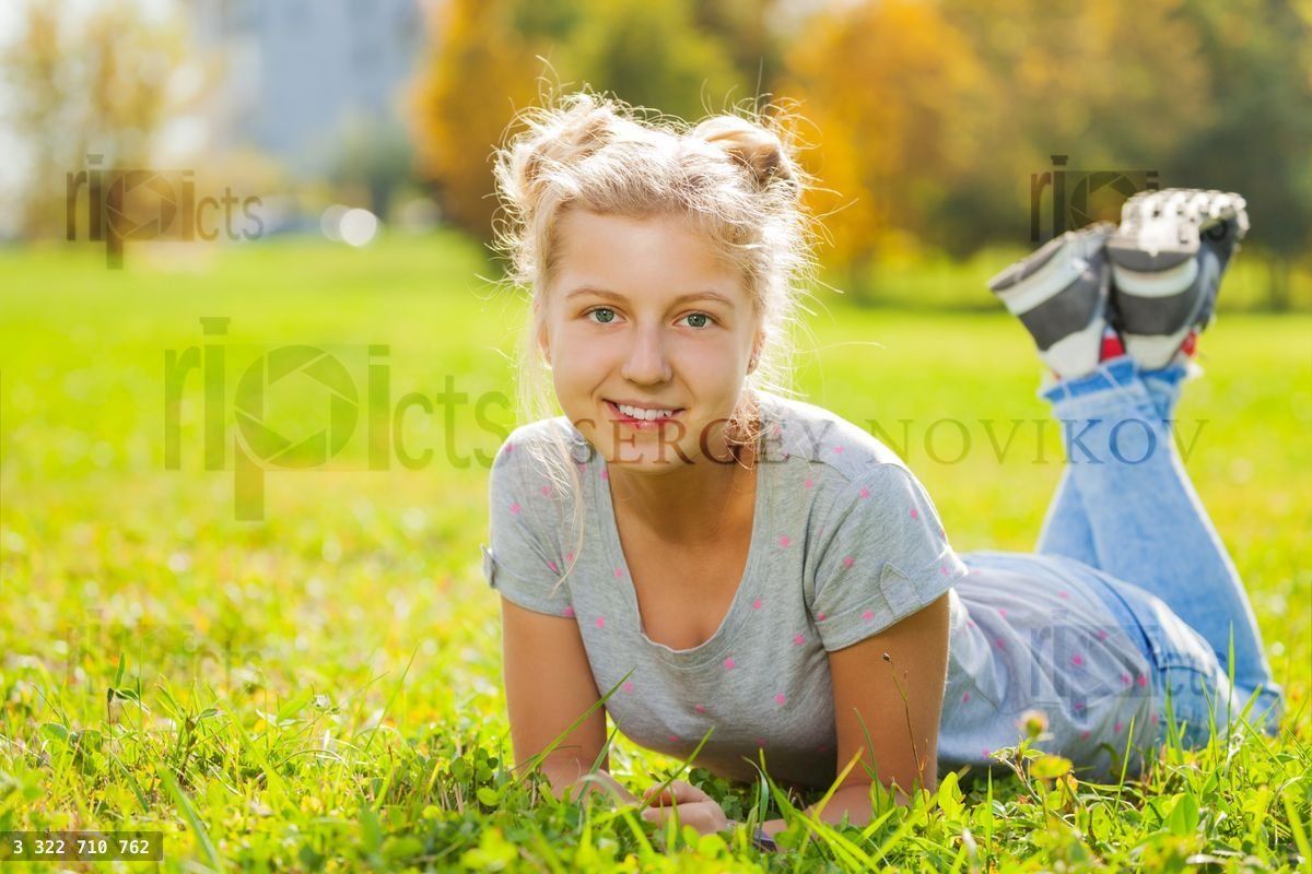 Girl close up view laying on green grass
