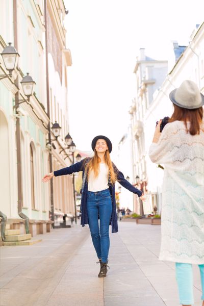 Girl shooting her friend with professional camera
