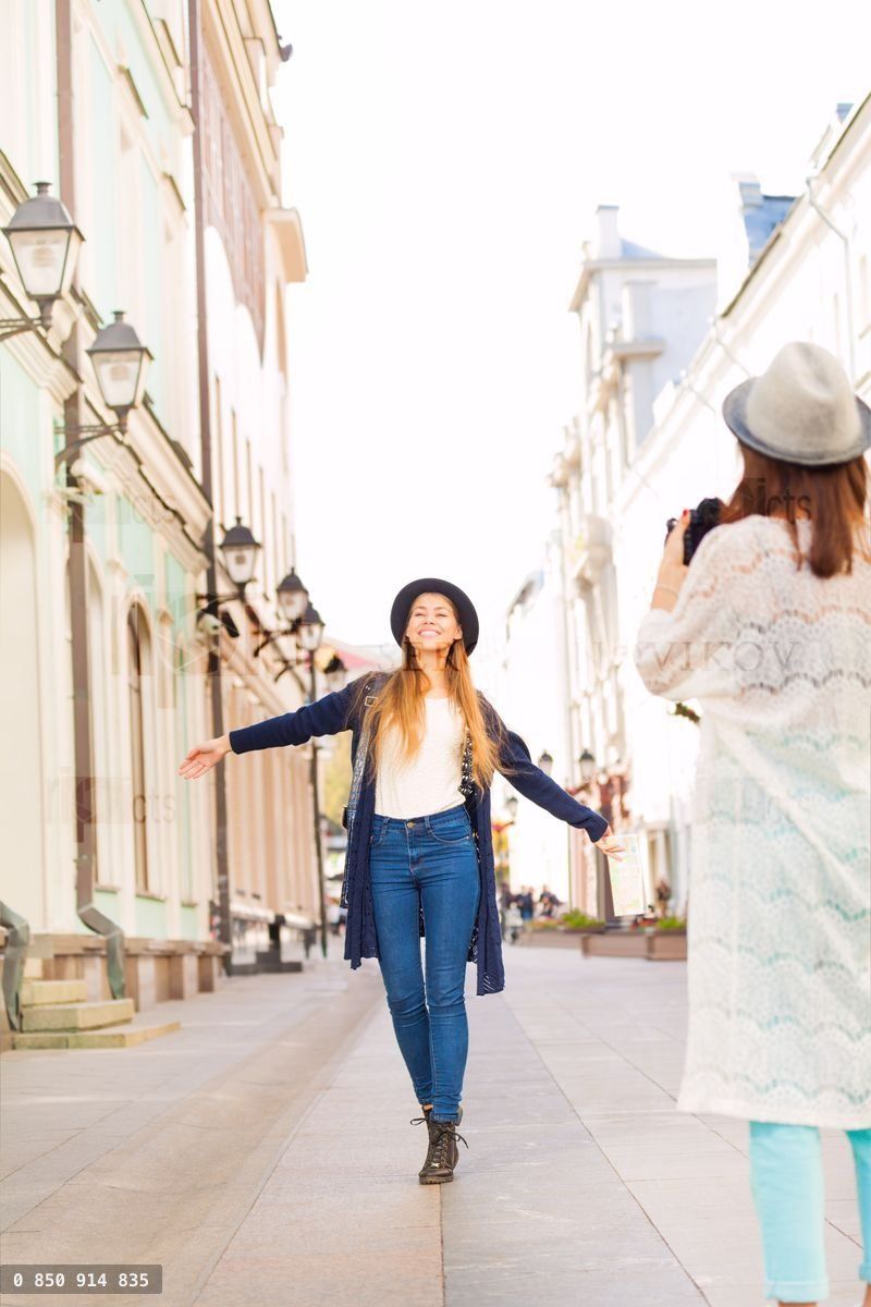 Girl shooting her friend with professional camera