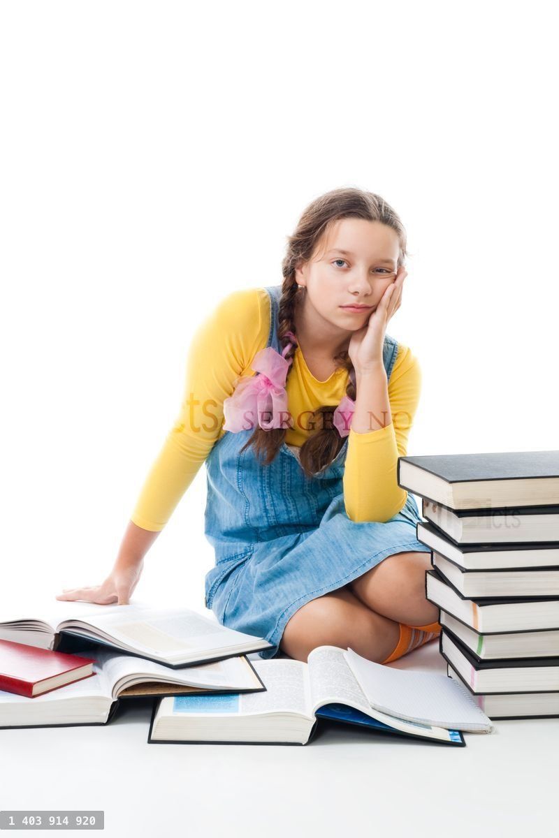 Young sad teenager girl tired from learning