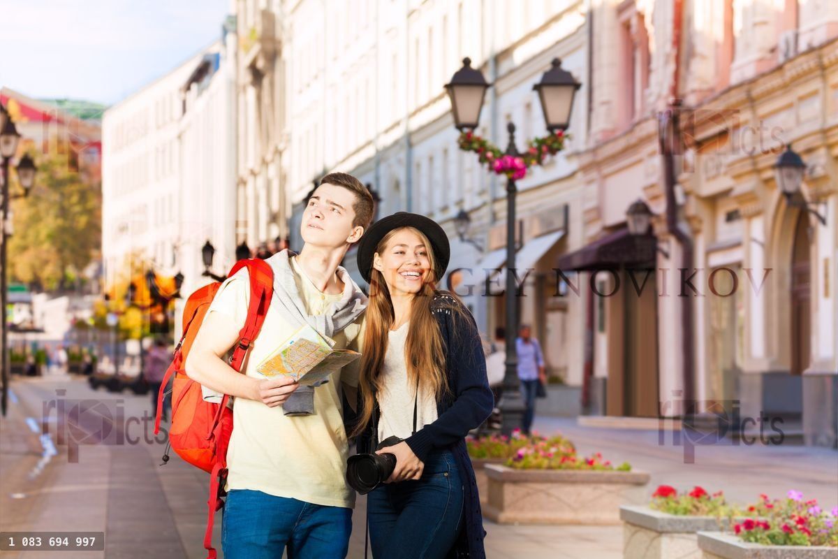 Beautiful woman and man as tourists sightseeing