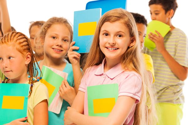 Girl with textbook in large group of children