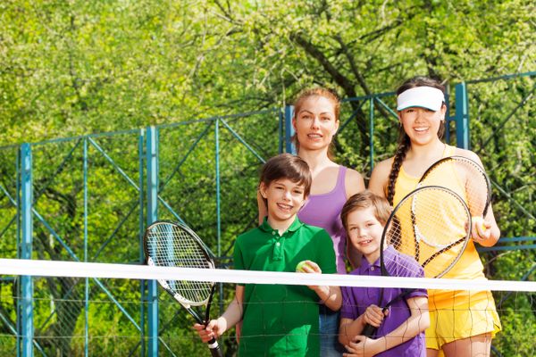 Sporty family preparing to start a tennis set